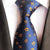Cravate Bleue à Fleurs Oranges et Pois Blancs